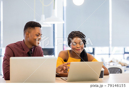 african college university students using laptop together . african college university students using laptop together . 79146155