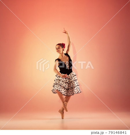 Young and incredibly beautiful ballerina is posing and dancing at red studio full of light. Young and incredibly beautiful ballerina is posing and dancing at red studio full of light. 79146841