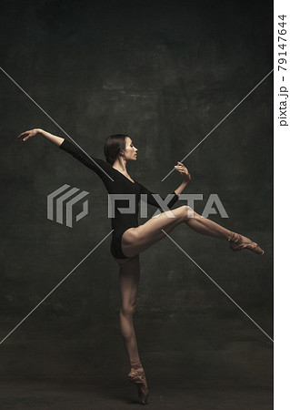 Young and graceful ballet dancer isolated on dark background. Art, motion, action, flexibility, inspiration concept. Young and graceful ballet dancer isolated on dark background. Art, motion, action, flexibility, inspiration concept. 79147644