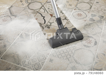 Vacuum cleaner on porcelain stoneware floor with copyspace for text Vacuum cleaner on porcelain stoneware floor with copyspace for text 79148060
