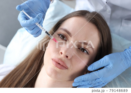 Young woman receiving anti-aging injection in beauty clinic 79148689
