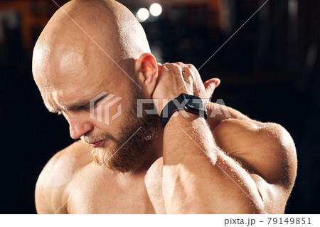 Handsome sportsman cringing from neck muscle soreness Handsome sportsman cringing from neck muscle soreness 79149851