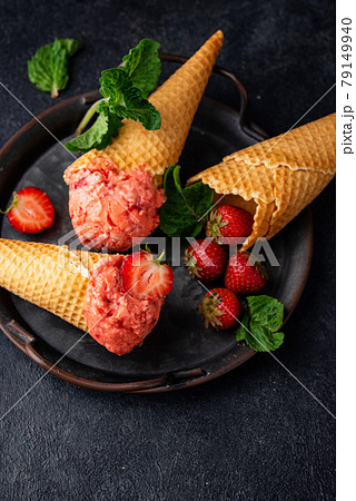 Strawberry ice cream in waffle cone Strawberry ice cream in waffle cone 79149940