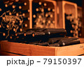 Dusty bottles of red wine in wooden crate 79150397
