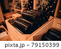Dusty bottles of wine in storage room or wine cellar 79150399