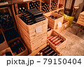 Wooden crates with wine bottles in storage room 79150404