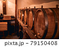 Wooden barrels with wine in storage room 79150408