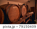 Traditional oak barrels with wine in storage room 79150409