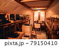 Storage room with wine in bottles and barrels. 79150410