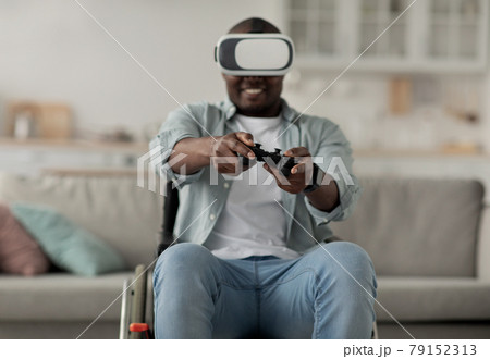 African american millennial man relax in living room interior, play video game, using gamepad 79152313