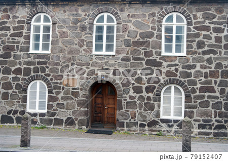 Old stony building with windows. Wall made out of big stones.  79152407