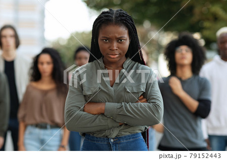 Closeup of angry black lady over demonstrators making riot outdoors 79152443