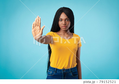 Determined African American Woman Gesturing Stop To Camera, Blue Background Determined African American Woman Gesturing Stop To Camera, Blue Background 79152521