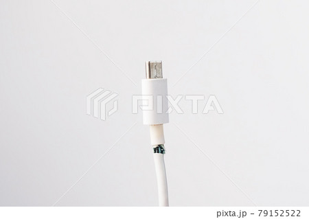 Torn cord for charging a mobile phone type si on a white background. Copy space. 79152522