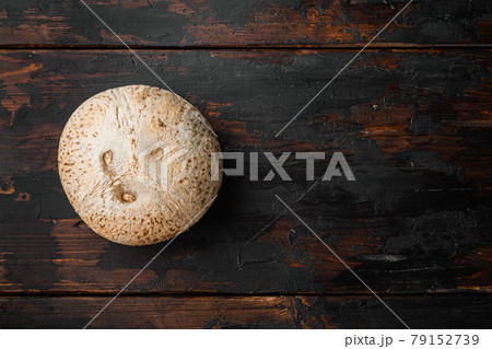 Freshly harvested coconut, on old dark wooden table background, top view flat lay, with copy space for text 79152739