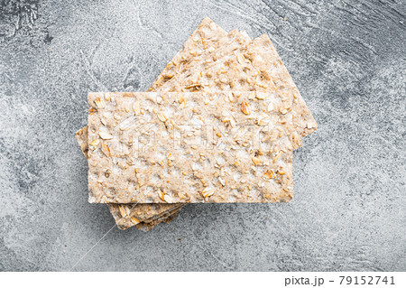 Whole grain crisp bread, on gray stone table background, top view flat lay Whole grain crisp bread, on gray stone table background, top view flat lay 79152741