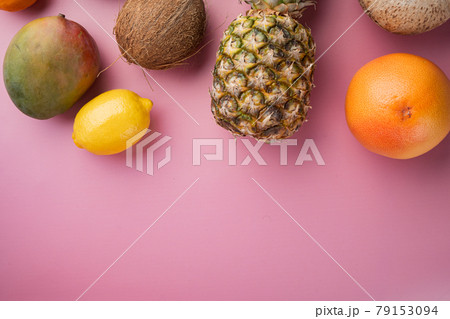 Assortment of different fruits, on pink textured summer background, top view flat lay, with copy space for text Assortment of different fruits, on pink textured summer background, top view flat lay, with copy space for text 79153094