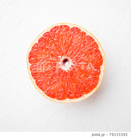 Ripe slice of pink grapefruit citrus fruit , on white stone table background, square format, top view flat lay 79153392