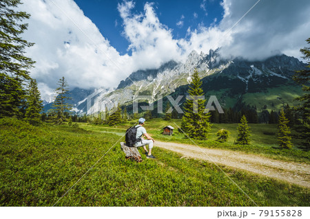 Traveler resting on hiking trail enjoying Wilder Kaiser mountains, Tirol - Austria 79155828