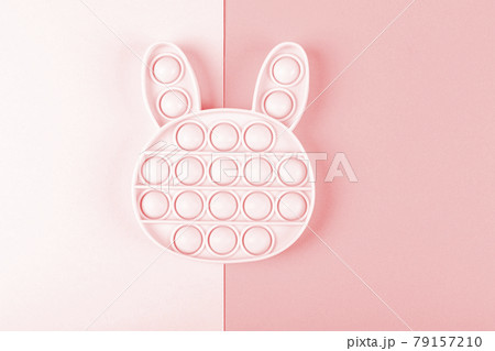 New silicone fidget toys pop it in shape of bunny on the pink background. 79157210