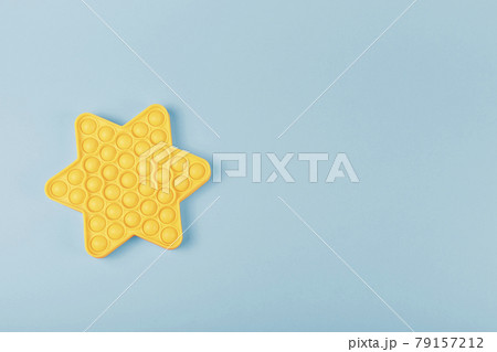 New silicone fidget toy pop it in shape of star on the blue background. New silicone fidget toy pop it in shape of star on the blue background. 79157212