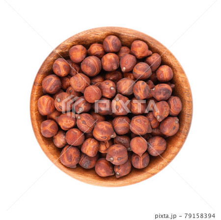 Pile of brown chickpeas in wooden bowl, isolated on white background. Brown chickpea. Garbanzo, bengal gram or chick pea bean. Top view. 79158394