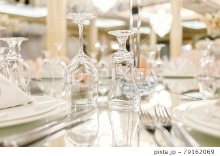 Mirror table festive setting in luxury restaurant. Glasses, plates, cutlery on mirror table. shallow depth of field Mirror table festive setting in luxury restaurant. Glasses, plates, cutlery on mirror table. shallow depth of field 79162069