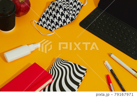 Stationery Keyboard Mask and Hand Sanitizer Against Orange Table. 79167971