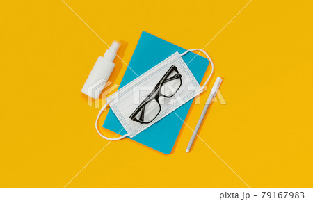 Notepad Glasses Pen Mask and Sanitizer Against an Orange Background. 79167983