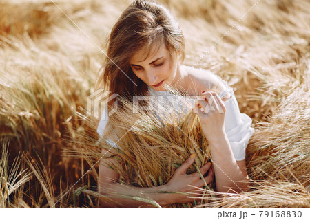 Beautiful girl in a autumn field 79168830