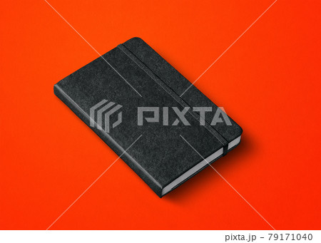 black closed notebook isolated on red black closed notebook isolated on red 79171040