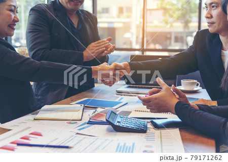 Team Business Partners shaking hands together to Greeting Start up small business in meeting room. Shakehand teamwork partners at modern office handshake together. Business mergers and acquisitions 79171262