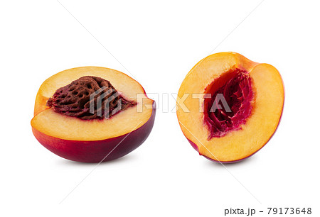 Two halves of smooth-skinned nectarine fruit with kernel and without it isolated on white background with copy space for text or images. Close-up. 79173648