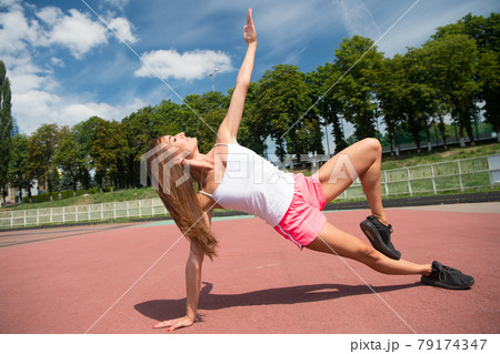 She is healthy and muscular. Muscular woman training  79174347