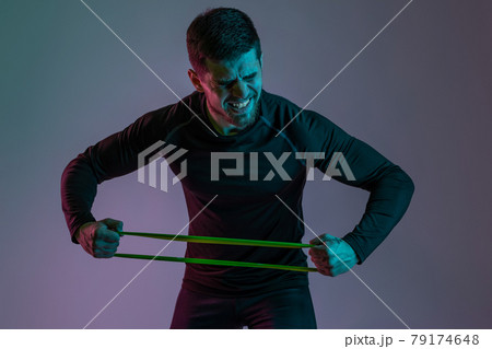 Expressive athlete stretching resistance elastic band with hands 79174648