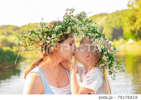 portrait of mother with daughter in chamomile wreath 79176819