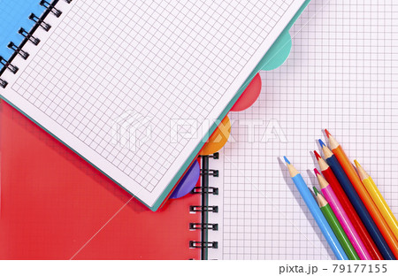 colored notebooks and pencils. Pencils on an empty notebook colored notebooks and pencils. Pencils on an empty notebook 79177155