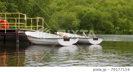boats with oars near the pier on the lake boats with oars near the pier on the lake 79177159