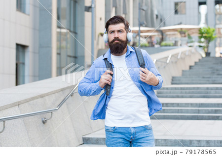 Listen to it, live it. Bearded man listen to music urban outdoors. 79178565