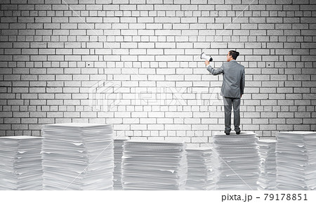 Businessman standing with megaphone. 79178851