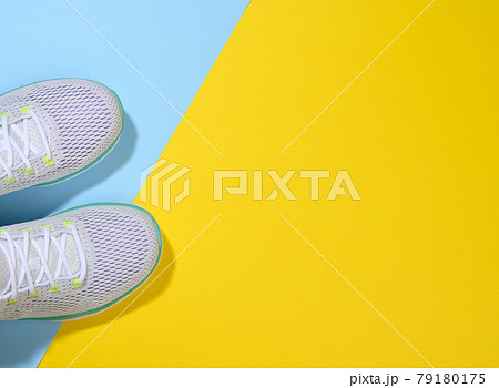 white women's sneakers with laces on a blue yellow background 79180175