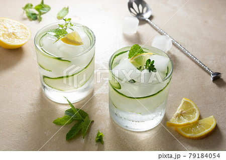 Cold lemonade with cucumber, lemon and ice. Summer refreshing drink. 79184054