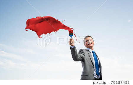 Creative businessman painter holding paintbrush 79187435