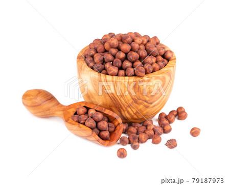 Pile of brown chickpeas in olive bowl and scoop, isolated on white background. Brown chickpea. Garbanzo, bengal gram or chick pea bean. Pile of brown chickpeas in olive bowl and scoop, isolated on white background. Brown chickpea. Garbanzo, bengal gram or chick pea bean. 79187973