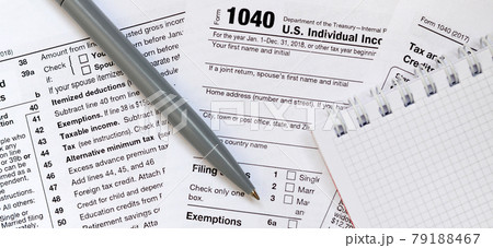 The pen and notebook is lies on the tax form 1040 U.S. Individual Income Tax Return. The time to pay taxes The pen and notebook is lies on the tax form 1040 U.S. Individual Income Tax Return. The time to pay taxes 79188467