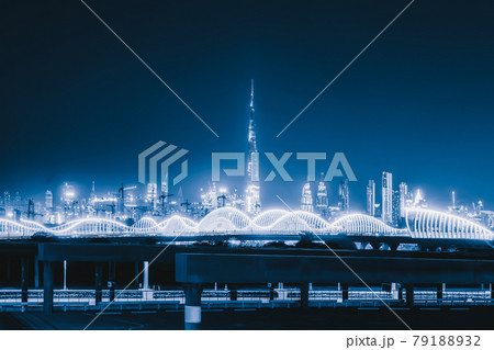 Meydan Bridge and street road or path way on highway with modern architecture buildings in Dubai Downtown skyline at night, urban city at night, United Arab Emirates or UAE. 79188932