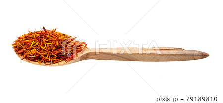 dried safflower petals in wooden spoon isolated dried safflower petals in wooden spoon isolated 79189810