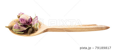 old dried rosebuds in wooden spoon isolated old dried rosebuds in wooden spoon isolated 79189817