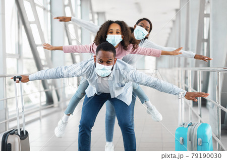 Happy black family traveling with daughter, having fun in airport 79190030