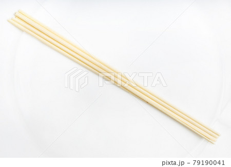dried round Udon noodles from wheat on white plate dried round Udon noodles from wheat on white plate 79190041